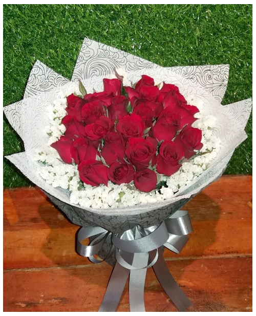 24 red roses with greenery